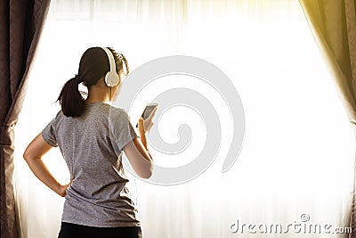 Woman watching online tutorials on mobile phone, training in living room Stock Photo