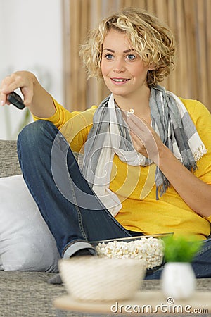 woman watching tv alone zapping channel Stock Photo