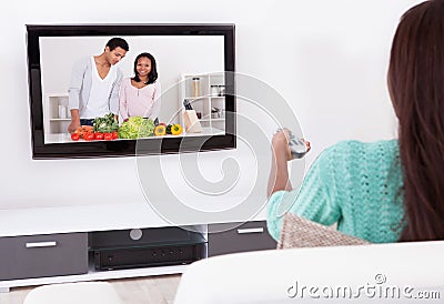 Woman watching tv in living room Stock Photo