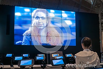 Woman watching video presentation about tolerance on large wall display Editorial Stock Photo