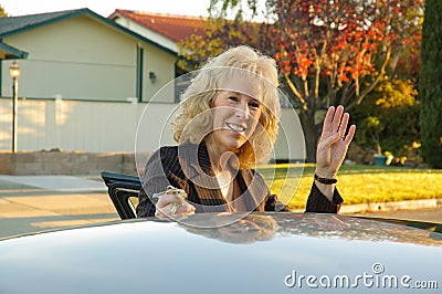 Woman waving goodbye Stock Photo