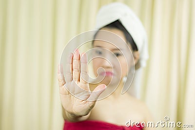 Woman wear a skirt to cover her breast after wash hair, Wrapped in Towels After Shower and giving gesture stop sign, stop symbol Stock Photo