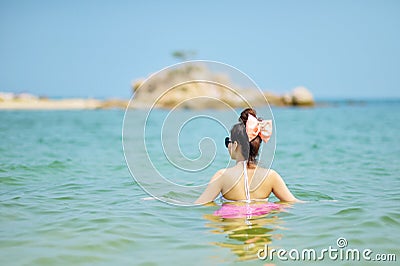 Woman wearing bikini standing at the sea. Stock Photo