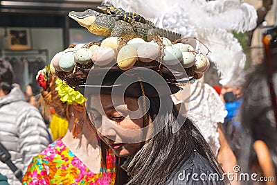 Woman wearing a bonnet featuring a lizard and its eggs at the Fifth Avenue Easter Parade Editorial Stock Photo