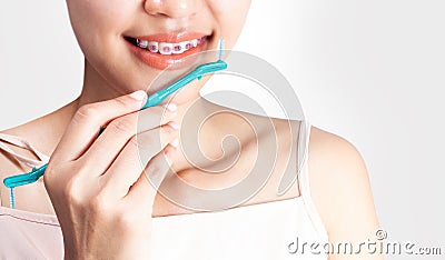 woman is wearing braces and using a cleaning teeth.. Stock Photo