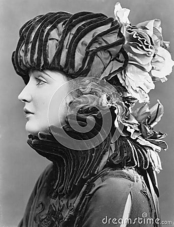 Woman wearing elaborate hat Stock Photo