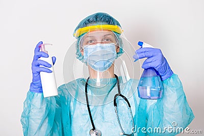 Woman wearing gloves, biohazard protective suit, face shield and mask with hand sanitizer bottle and disinfection gel. corona Stock Photo