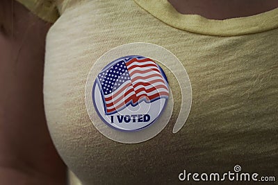 Woman wearing an I voted sticker on election day Stock Photo