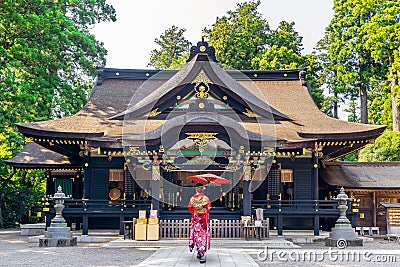 Woman wearing japanese traditional kimono with umbrella at katori shrine in Chiba, Japan Stock Photo