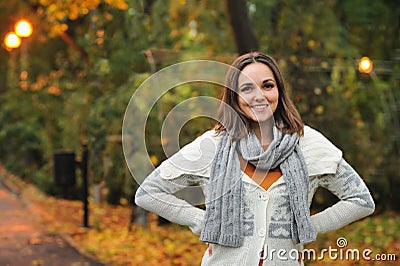 Woman wearing knitted jacket in autumn evening park. Stock Photo