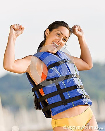 Woman wearing life jacket at beach Stock Photo