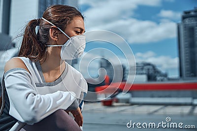 Woman wearing a mask in the city center Stock Photo