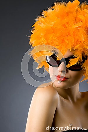Woman wearing an orange feather wig and sunglasses Stock Photo