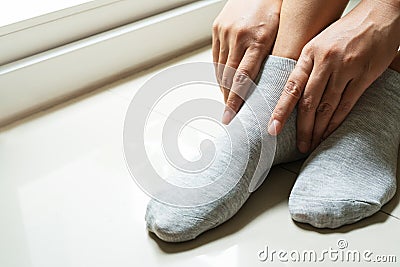 Woman wearing a pair soft grey sock Stock Photo