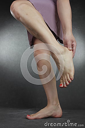 Woman wearing purple dress over grey Stock Photo