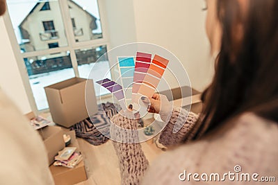 Woman wearing purple sweater holding papers with color variety Stock Photo