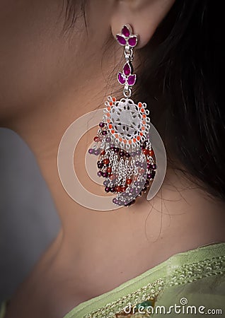 Woman wearing red earring on ear Stock Photo