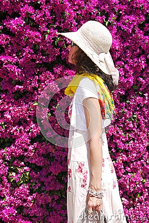 Woman smelling Bougainvillea blossoms Summer outdoor Stock Photo