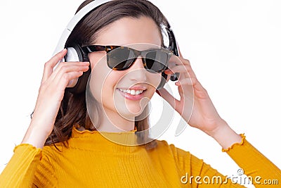 Woman wearing sunglasses and listening to headphones Stock Photo