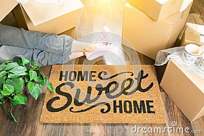 Woman Wearing Sweats Relaxing Near Home Sweet Home Welcome Mat Stock Photo