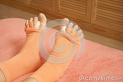 Woman wearing yoga toe separator socks in bed Stock Photo