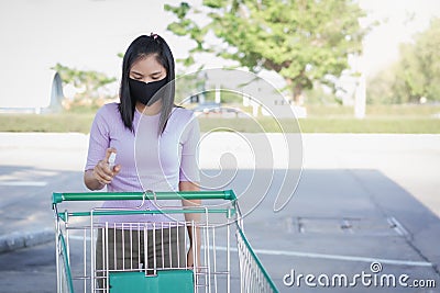 A woman wears a black mask and alcohol spray Stock Photo