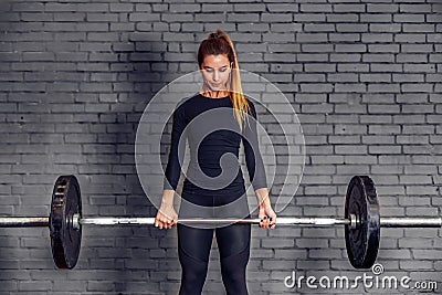 Woman with weight barbell doing deadlift exercise Stock Photo