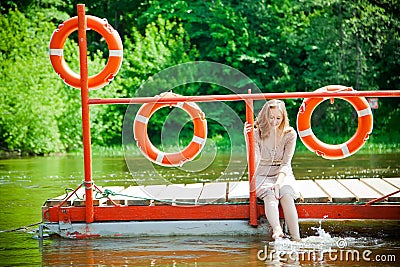 Woman wetting her feet in the river Stock Photo