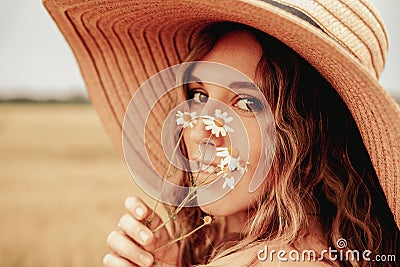 Woman wheat field nature. Happy young woman in sun hat in summer wheat field at sunset. Copy space, sunset, flare light Stock Photo