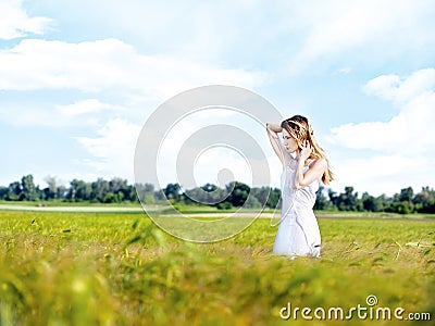 Woman at wheat field on sunny day Stock Photo