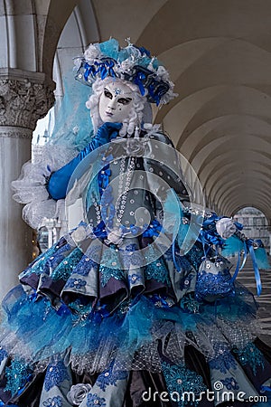 Close up of woman mask under the arches at the Doges Palace, Venice, Italy during the carnival Editorial Stock Photo