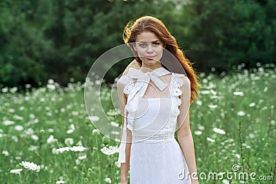 Woman in white dress in a field walk flowers vintage nature Stock Photo