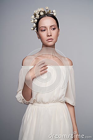 Woman in white greek dress with flowers on her head Stock Photo