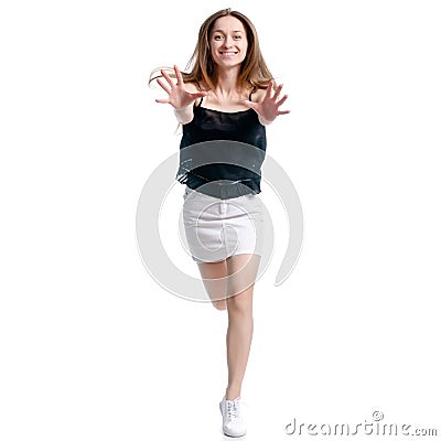 Woman in white skirt and black shirt running smiling Stock Photo