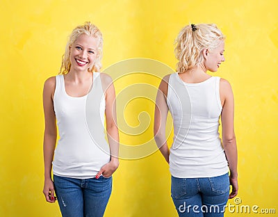 Woman in white tanktop on yellow background Stock Photo