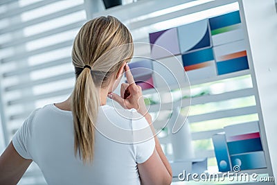 Woman in white tshirt choosing medicine and hesitating Stock Photo