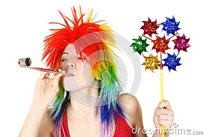 Woman in wig with party blower and pinwheel Stock Photo