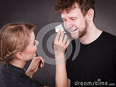 Woman wipe man face by hygienic tissue Stock Photo