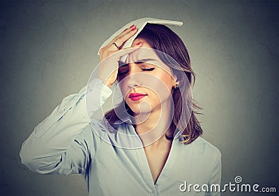 Woman wipes sweat from her forehead with a handkerchief Stock Photo