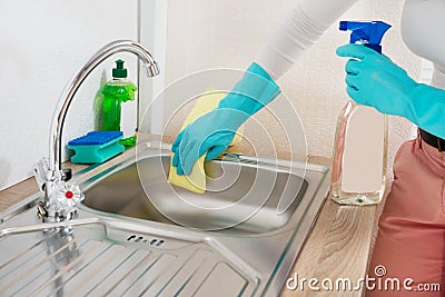 Woman Wiping Kitchen Sink Stock Photo