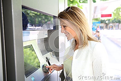 Woman withdrawing money from distributor Stock Photo
