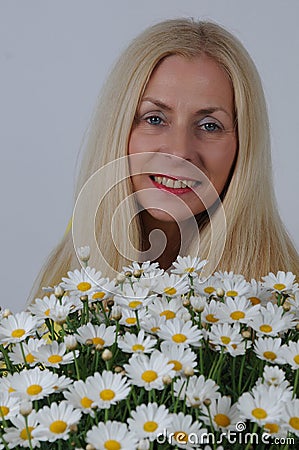 Woman with oxeye daisy flowers Stock Photo