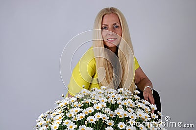 Woman with oxeye daisy flowers Stock Photo