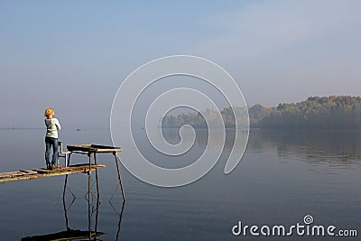 Woman wooden bridge travel meditation reflection thought river Editorial Stock Photo