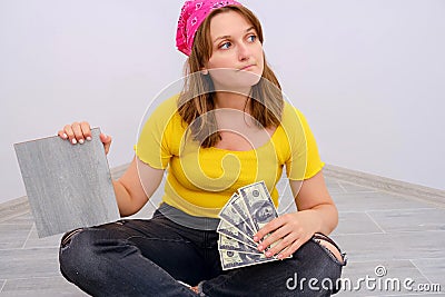 Woman worker looks thoughtfully to the side. Problems with spending money on apartment renovation. Not enough money for expensive Stock Photo