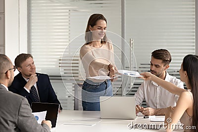 Woman worker share handout materials at briefing in office Stock Photo