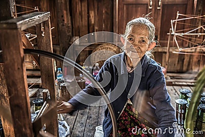 Woman worker weaves fabric in a weaving factory Editorial Stock Photo