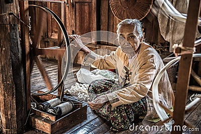 Woman worker weaves fabric in a weaving factory Editorial Stock Photo