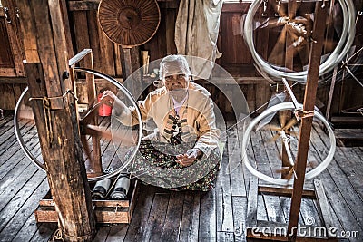 Woman worker weaves fabric in a weaving factory Editorial Stock Photo