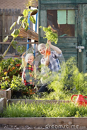 Woman working on allotment with child Stock Photo